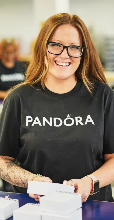 Pandora employees packaging jewelry in a distribution center.